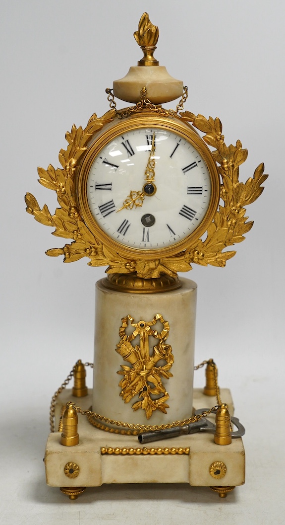 A late 19th century French alabaster and gilt metal timepiece with enamel dial, with key, 31cm high. Condition - fair